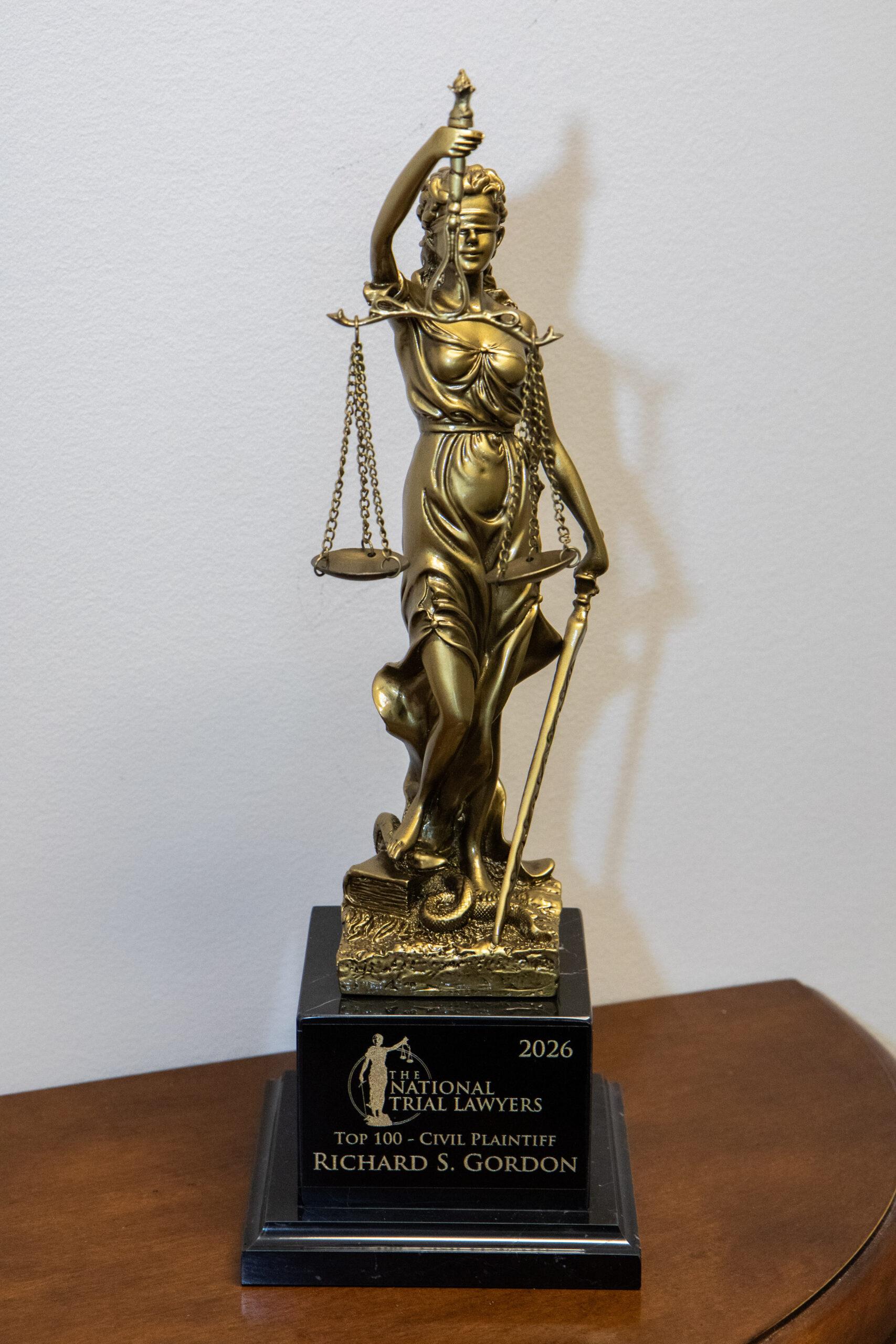 Gold Lady Justice trophy honoring Richard S. Gordon as a National Trial Lawyers Top 100 Civil Plaintiff attorney, 2026
